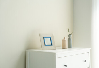 white vase with flowers and frame