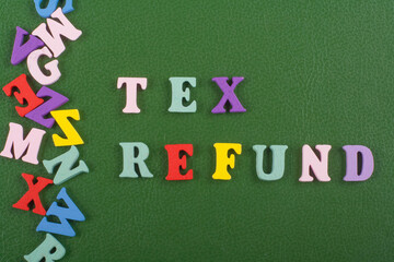 TEX REFUND word on green background composed from colorful abc alphabet block wooden letters, copy space for ad text. Learning english concept.