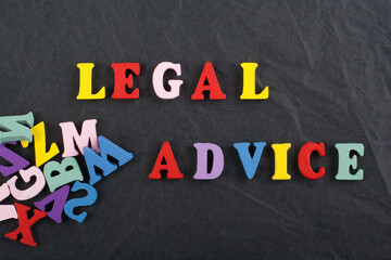 Obraz premium LEGAL ADVICE word on black board background composed from colorful abc alphabet block wooden letters, copy space for ad text. Learning english concept.