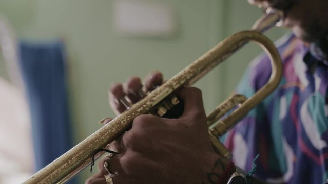 African American man playing the trumpet, practicing latin jazz 
