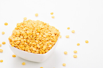 Uncooked chana dal in bowl on white background