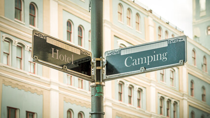 Signposts the direct way to Camping versus Hotel