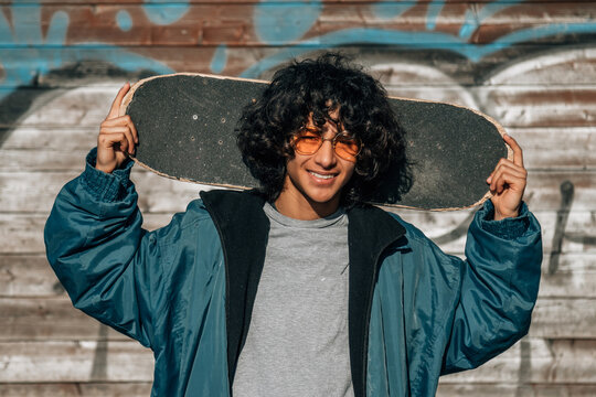 teenager boy with skateboard on the street