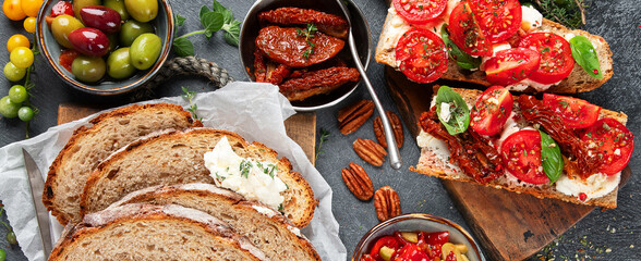 Italian antipasti snacks set. Tasty bruschettas with cheese, sun-dried tomatoes. Traditional food concept