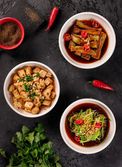 Asian dishes with chicken and green onions, top view