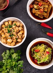 Asian dishes with chicken and green onions, top view