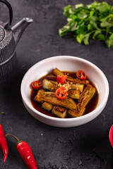 fried eggplant in soy sauce with garlic side view