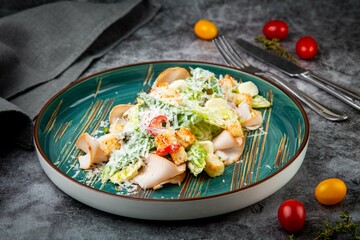 side view of caesar salad with cheese on a blue plate