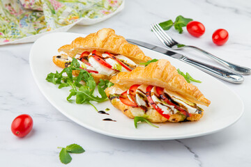 croissants with cheese, vegetables, cherry tomatoes and herbs