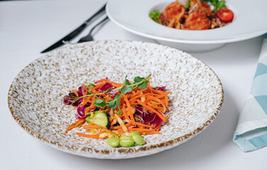 carrot salad with cucumbers, beans and herbs, side view