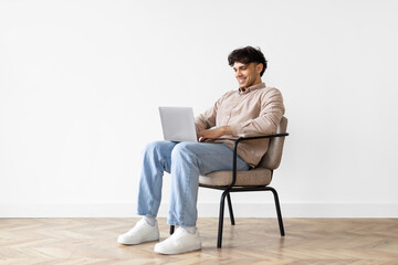 Man With Laptop In Chair On White Background At Home