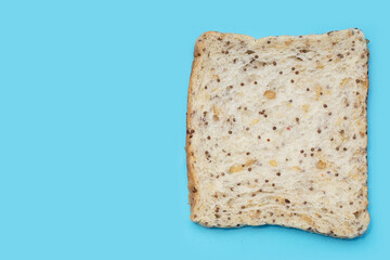 Whole grain bread slices on blue background.