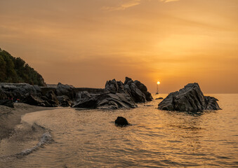 Sunset on the famous Michelino beach with mist on the horizon, Parghelia - Tropea, Vibo Valentia, Calabria, Italy