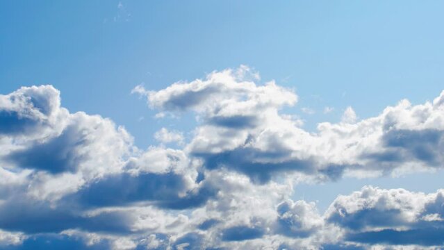Blue sky and white clouds. Puffy fluffy white clouds. Cumulus cloud cloudscape timelapse. 4k video HD. Summer blue sky time lapse. Nature weather blue sky. White clouds background. Cloud time lapse