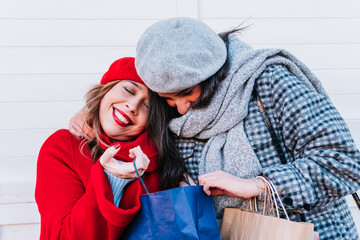 Two women with shopping bags in Christmas and winter.