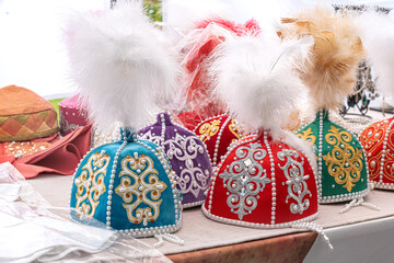 Traditional headdresses for girls of Kazakhstan and Central Asia with feathers are sold on a street...