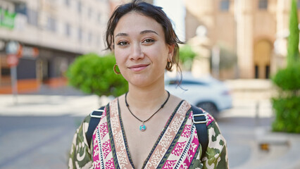 Young beautiful hispanic woman smiling confident standing at street