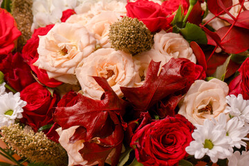 Autumn bouquet of red and white roses, hydrangeas, chrysanthemums as a background.