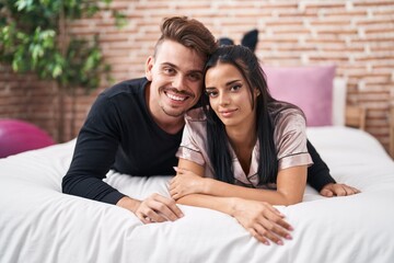 Man and woman couple smiling confident lying on bed at bedroom