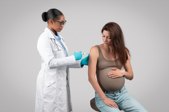 Serious African American Lady Doctor Make Injection To Pregnant Patient During Pregnancy