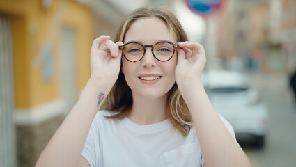 Young caucasian woman smiling confident wearing glasses at street