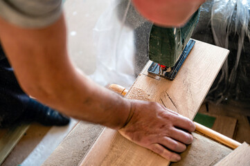 handyman Installing laminate flooring, carpenter cut parquet floor board with electric jigsaw