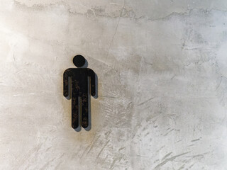 Black Men's Toilet Symbol on Grungy Concrete Wall