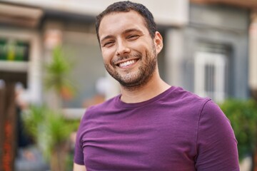 Fototapeta premium Young man smiling confident standing at street