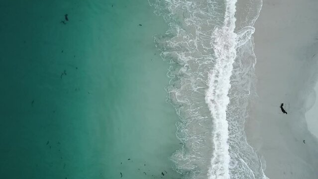 Aerial drone video of waves coming into shore