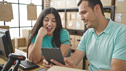 Two coworkers working using touchpad at ecommerce office