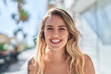 Fototapeta premium Young blonde woman smiling confident standing at street