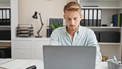 Young caucasian man business worker using laptop working at office