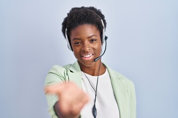 African american woman wearing call center agent headset smiling cheerful offering palm hand giving...