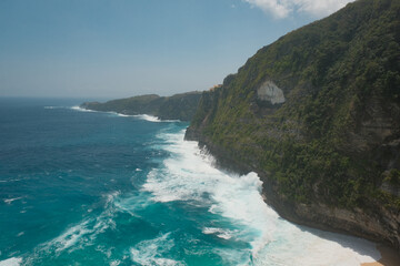 Cliff Range Overlooking Foamy Waters and the Serene Turquoise Shore of Nusa Penida