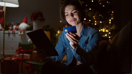 Young caucasian woman doing christmas online shopping with tablet at home