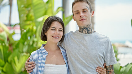 Obraz premium Beautiful couple smiling confident hugging each other at park