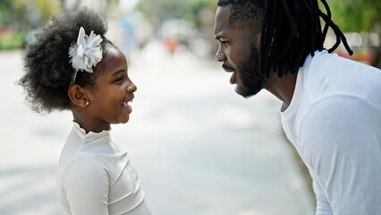 African american father and daughter smiling confident standing together at street