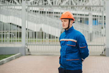 worker in blue uniform walking outdoors on a construction site