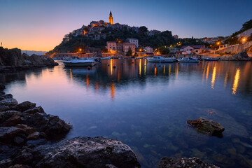 Cityscape of Vrbnik with marina in the morning before sunrise. A Croatian town on a hill on the island of Krk