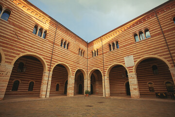 Fototapeta na wymiar Fair Verona concept. Сortile del Tribunale in old city centre. Outdoor shot with perspective