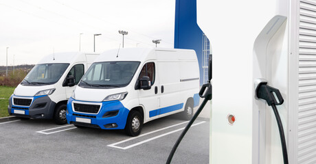 Electric delivery vans with electric vehicles charging station. © scharfsinn86
