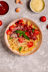 Homemade pasta with tomato sauce, top view.