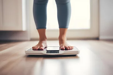 Foto op Canvas Close up of woman bare feet standing on digital electronic weight scale at home. Diet and overweight concept. © AspctStyle
