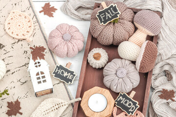 Cozy autumn mood composition. Handmade decor for home, traditional fall symbols - knitted props