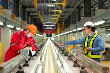 After the electric train is parked in the electric train repair shop, Electric train engineer and technician with tools inspect the railway and electric trains in accordance with the inspection round