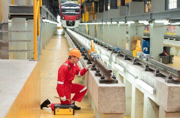 After the electric train is parked in the electric train repair shop, an electric train technician with tools inspect the railway and electric trains in accordance with the inspection round