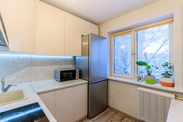 interior apartment kitchen and dining room, refectory area, cooking equipment, table furniture, stove