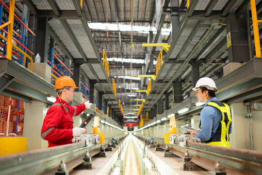 After the electric train is parked in the electric train repair shop, Electric train engineer and technician with tools inspect the railway and electric trains in accordance with the inspection round
