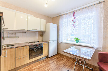 interior apartment kitchen and dining room, refectory area, cooking equipment, table furniture, stove