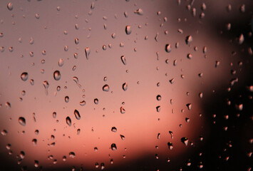 Raindrops in the glass during sunset.